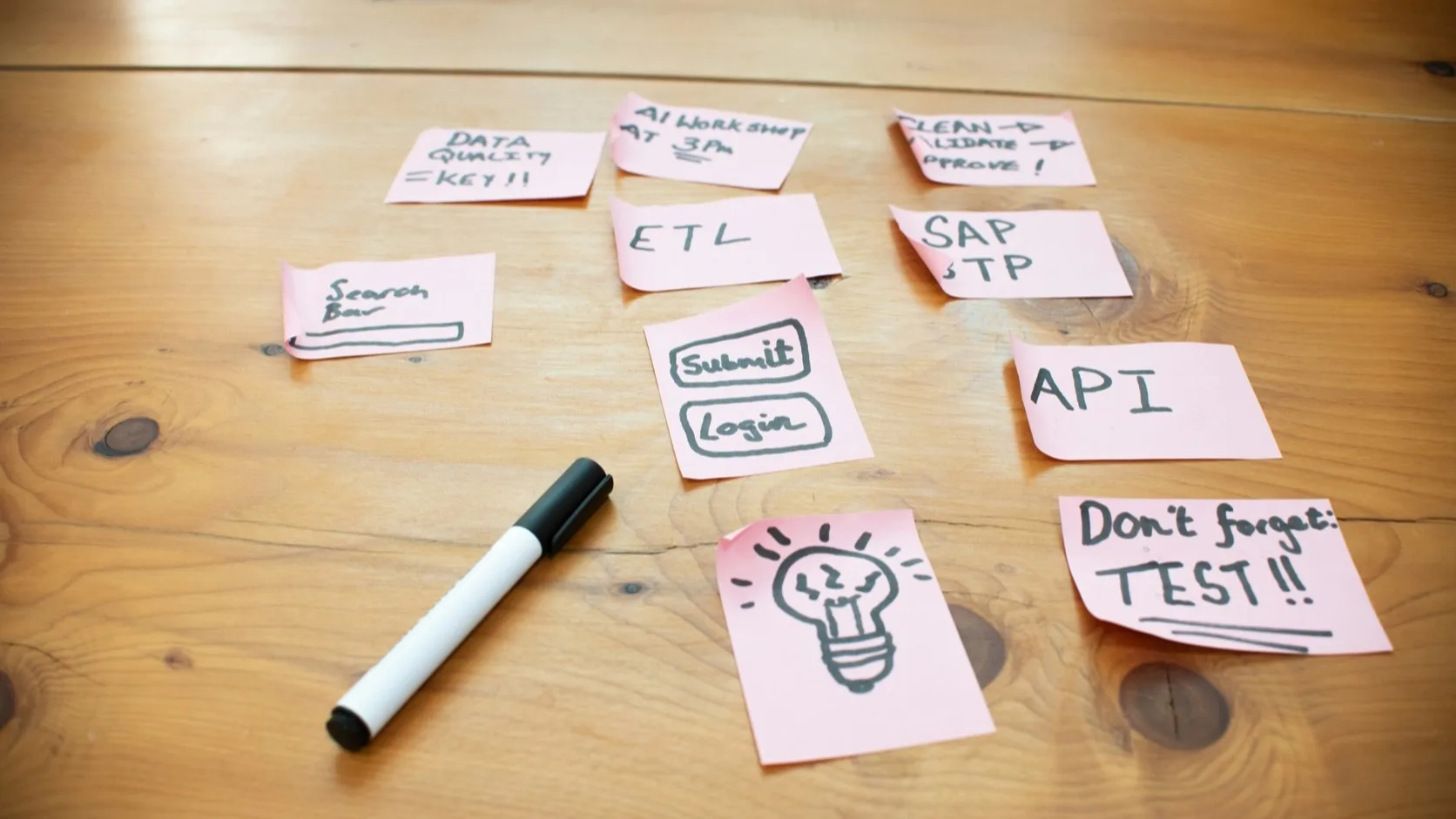 A founder planning a business idea validation test with notes, sketches, and a laptop before building a product