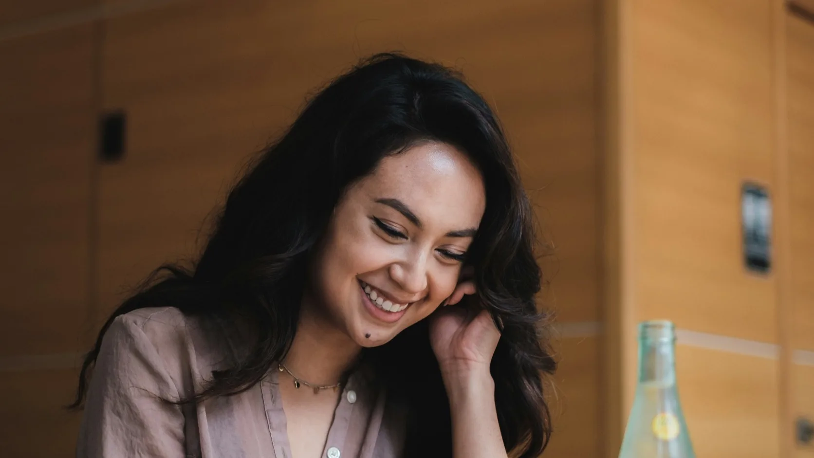 A person smiling while reading a flirty text message on a smartphone